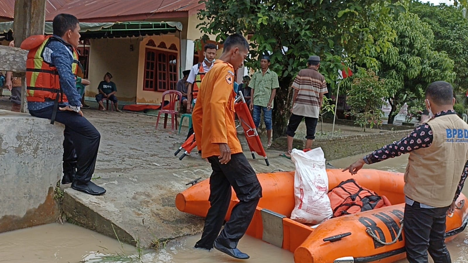 Membagikan nasi swadaya dan evakuasi warga di desa sei silau tua, kondisi ketika banjir belum surut